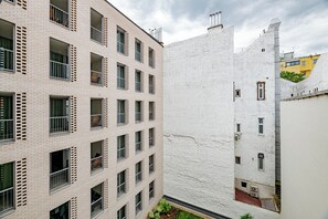 A multi-story building with a brick facade and white walls, featuring multiple windows and balconies. - A60 Boutique Hotel (Budapest)