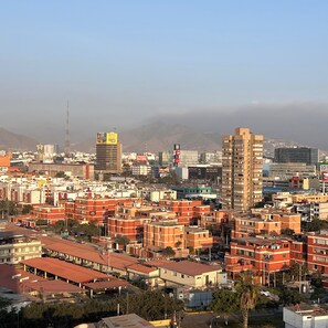 A cityscape with dense urban buildings, a prominent tower, and a clear sky. - Vibrant City Hub | Connectivity | Steps from San Borja San Isidro Biz Districts (La Victoria)