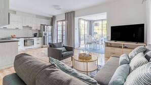 A modern apartment with a kitchen, living room, and balcony. - Imperial Apartments - Bernadowska (Gdynia)
