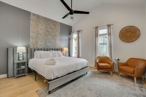 A modern bedroom with a large bed, a ceiling fan, a nightstand with a lamp, and two chairs. - < 2 Mi to Dtwn! Group Escape w/ Grill in Houston (Houston)