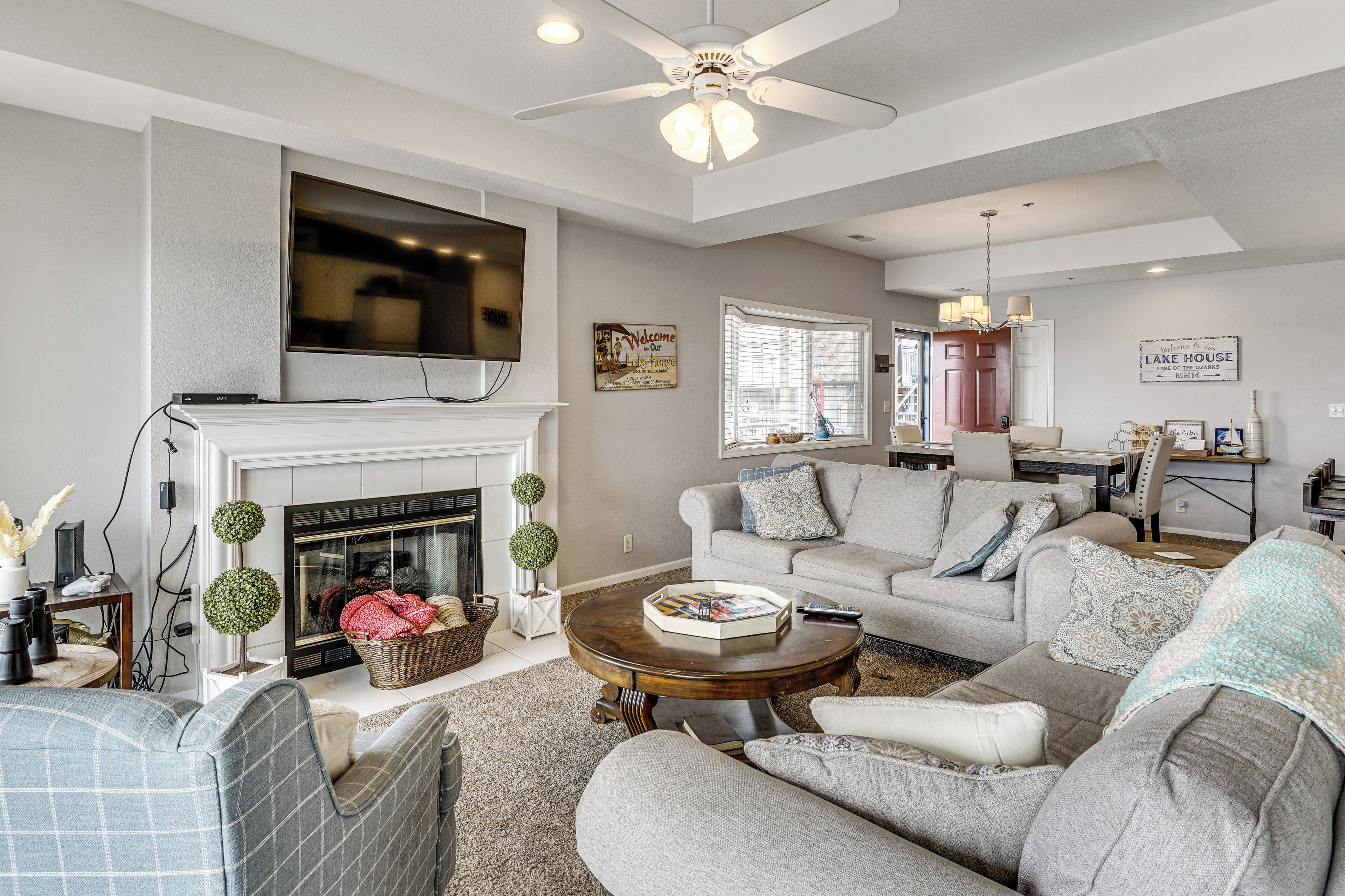A living room with a fireplace, a television, a sofa, and a coffee table.