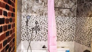 A bathroom with a bathtub, toilet, and shower area. - 
Charming Newari-modern homestay in Patan, cozy stay near heritage sites (Lalitpur)
