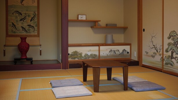A traditional Japanese room with tatami flooring, a low wooden table, cushions, a red vase, and artwork on the walls. - YORIDOKORO (Oma)