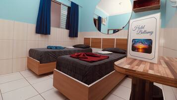 A bedroom with two beds, a wooden table, a mirror, and a 'Hotel Bellamy' sign.