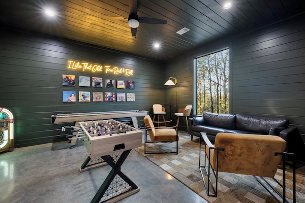 Game room lounge with shuffleboard, foosball & record wall—perfect for group fun