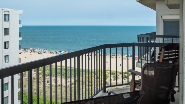 A balcony with a view of the beach and ocean. - Oceanfront Building With Great Ocean and Bay Views (Ocean City)