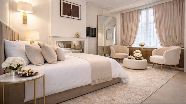 A bedroom with a large bed, bedside tables, a mirror, a TV, and a window with curtains. - Luxury Pad for Couples Next to Paddington Station (London)