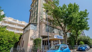 A multi-story building with a sign indicating it is a staff hotel. - Only Room Hotel  (Lido di Savio)