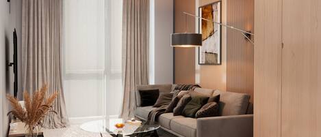 A modern living room with a sofa, a coffee table, and a lamp.