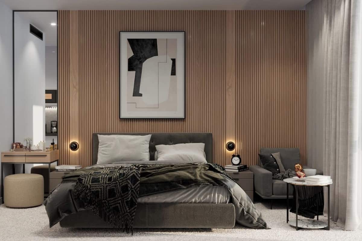 A modern bedroom with a bed, bedside tables, a small sofa, and a side table.