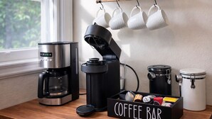 A kitchen with a coffee bar, a kettle, a coffee maker, mugs, and storage containers. - Walk to Town & River • Fire Pit • King Bed (Kerrville)