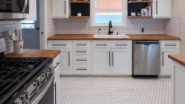 A modern kitchen with white cabinets, a stainless steel stove, and a dishwasher. - Walk to Town & River • Fire Pit • King Bed (Kerrville)