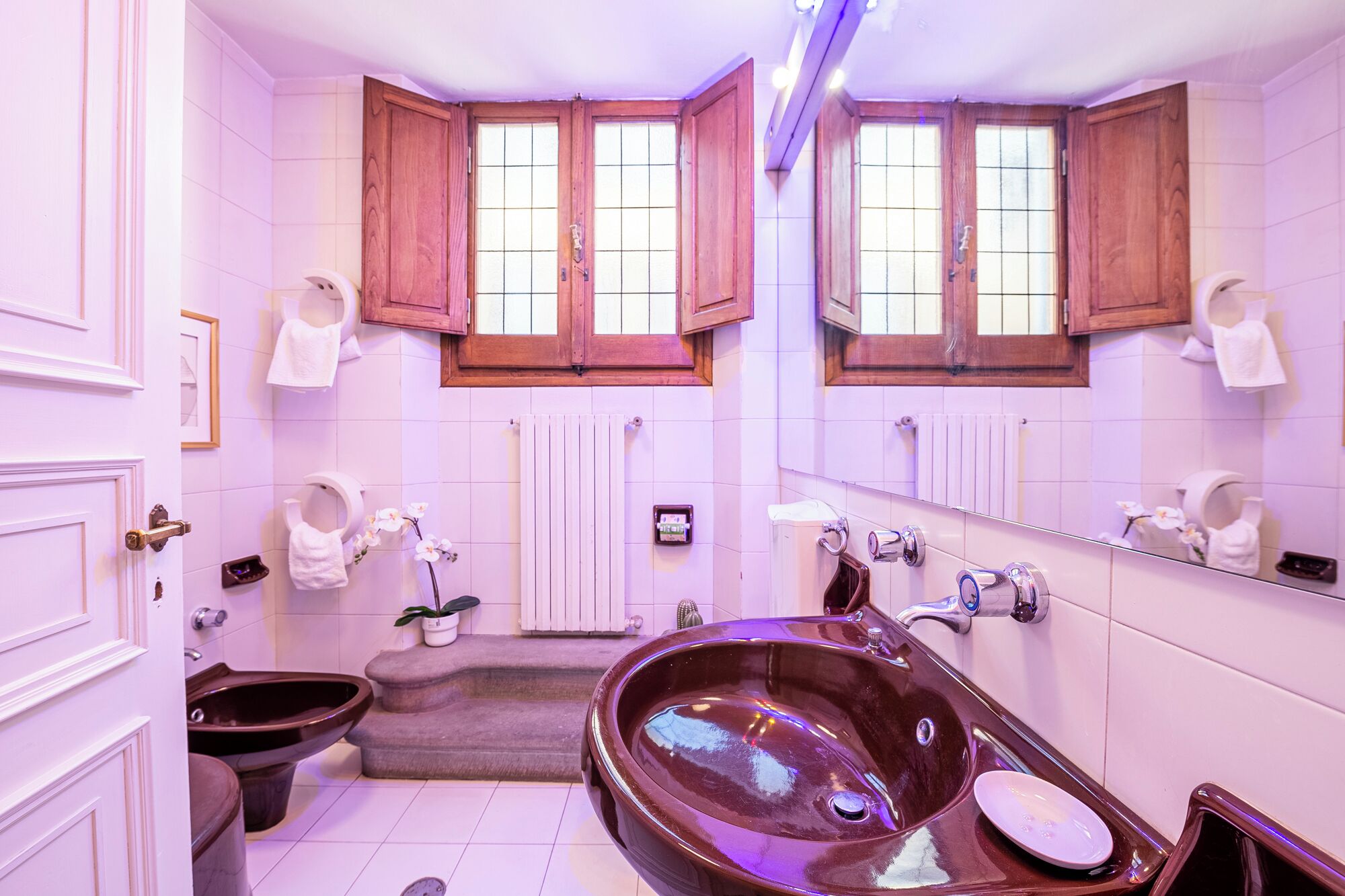 A bathroom with a large bathtub, a toilet, and a sink.