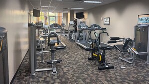 A gym with treadmills, elliptical machines, and weight equipment. - Magical Condohotel at Resort Lake Buena Vista (Orlando)