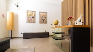 A modern reception area with a desk, glass shelving, and artwork on the wall. - KANISA MARI E MONTI (Cinisi)