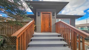 A wooden staircase leading to a door with a number 30 sign above it.