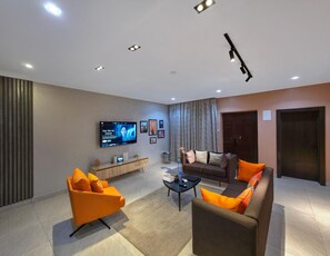 Deluxe Room, Balcony, City View | Living area