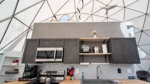 A modern kitchen with a microwave, stove, and sink.
