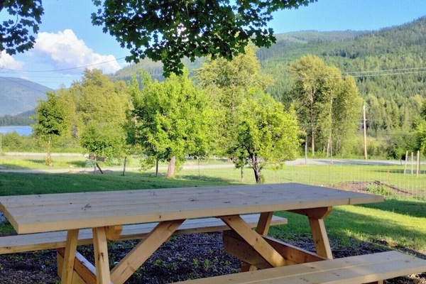 outdoor space with picnic table and lake view
