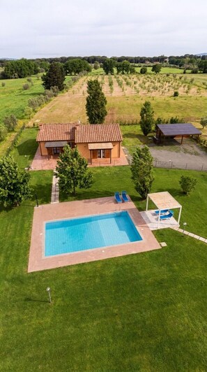 A house with a swimming pool, a patio with lounge chairs, and a solar panel. - Villa Il Bambuseto (Cecina)