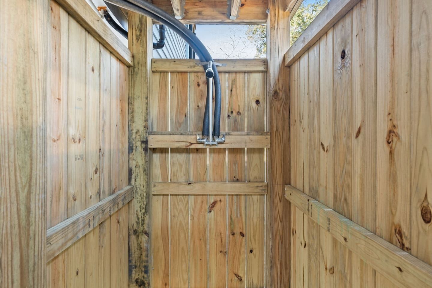 A wooden structure with a metal pipe running through it.