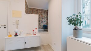 A modern bathroom with a white vanity, a potted plant, and a view of the outside. - Apartment for rent at Rua de Santo Estevão 25, Santa Maria Maior, Lisbon. (Lisboa)