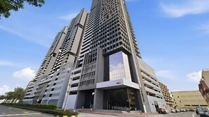 A high-rise building with a modern architectural design, featuring multiple floors and a prominent entrance.