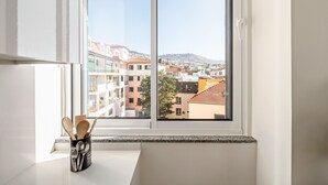A kitchen with a window view of a cityscape. - Sé Cathedral Rooftop, a Home in Madeira (Funchal)