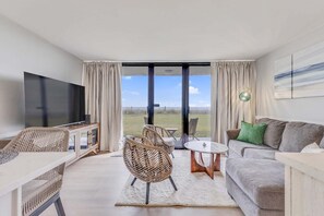 TV - Experience coastal charm at 0104 Seagrass Retreat, a 1-bedroom oceanfront condo in Carolina Beach. (Carolina Beach)