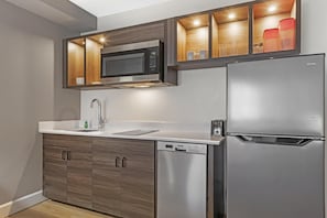 A modern kitchen with a built-in microwave, dishwasher, and refrigerator. - Executive Residency By Best Western Denver East (Denver)