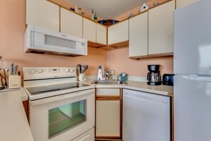 Fridge, microwave, oven, stovetop - Experience oceanfront luxury at 0411 Seaside Sunrise, Carolina Beach! (Carolina Beach)
