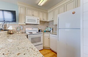 Fridge, microwave, oven, stovetop - Oceanfront 2BR condo in Carolina Beach with stunning views and shared pools. (Carolina Beach)