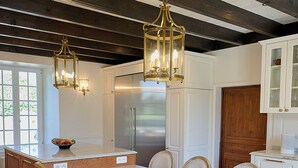 A kitchen with a large island, white cabinetry, and a hexagonal tile floor. - Charming manor house in Brittany (Binic-Étables-sur-Mer)