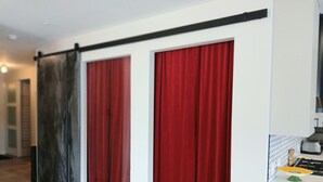 A room with a sliding door, a kitchen area with a gas stove, and a tiled floor. - Sunset Waterfront Resort, Crown Jewel of Kelowna. Panoramic Lake Views, floor 18 (Kelowna)