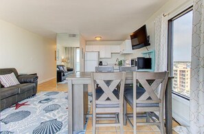 A compact living space with a kitchenette, a dining area, and a sofa. - Experience oceanfront bliss at 0901 Salty Dayz Tower 0901 (Carolina Beach)