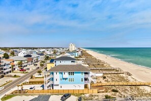 A coastal residential area with houses, a beach, and a clear sky. - Experience oceanfront bliss at 0901 Salty Dayz Tower 0901 (Carolina Beach)