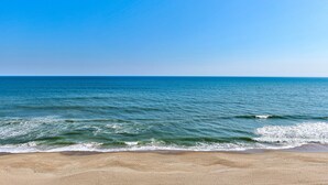 Ein Strand mit klarem, blauem Wasser und einem Sandufer.