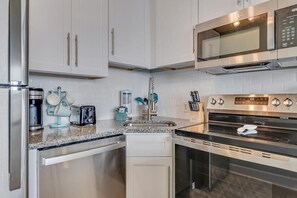 Fridge, microwave, oven, stovetop - Experience oceanfront luxury at 1108 Ocean Serenity, Carolina Beach. (Carolina Beach)