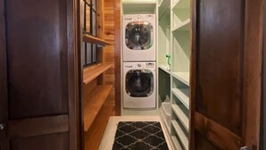 A narrow hallway with wooden walls and a double-door entrance. - Beautifully Chic, Spacious, WiFi, Near Pullman Yds (Atlanta)