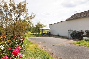 A paved driveway leading to a building with a covered outdoor seating area. - Gîte La Chapelière: Private Terrace, Garden & Wi-Fi in Assay, Loire Valley (Assay)