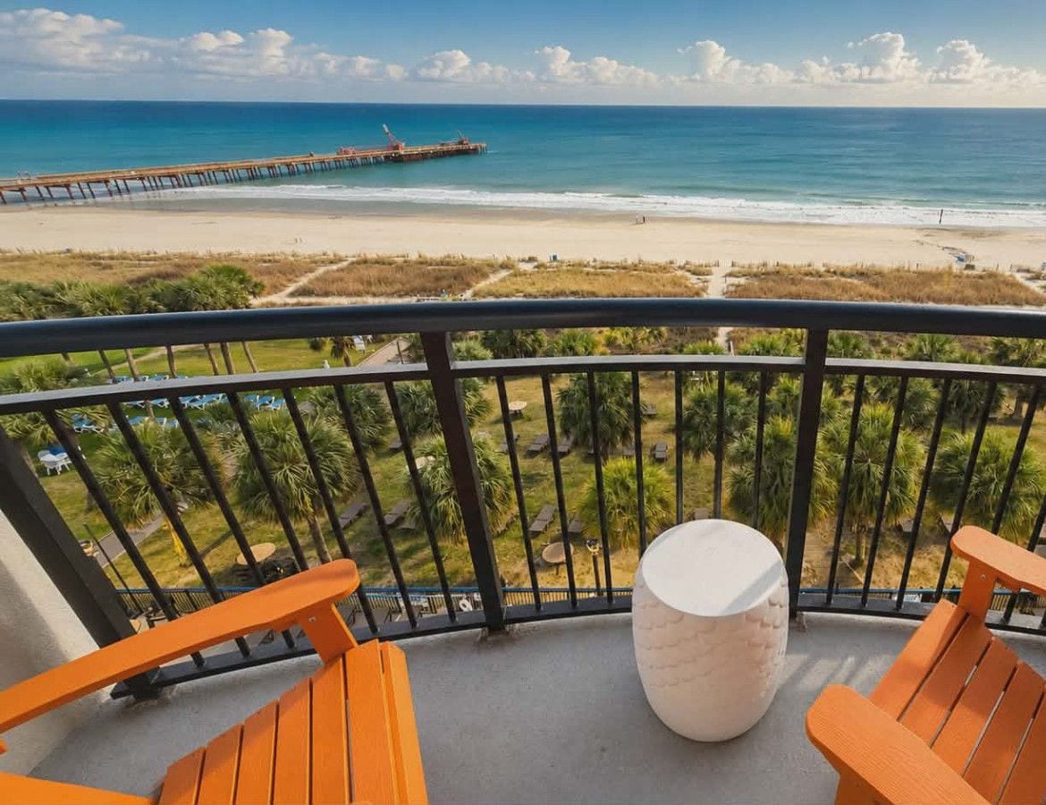 Private oceanfront balcony with direct beach and Atlantic views, plus a clear sightline to the nearby pier. Enjoy morning coffee at sunrise or unwind with evening ocean breezes from comfortable seating. A true Myrtle Beach beachfront experience right outs