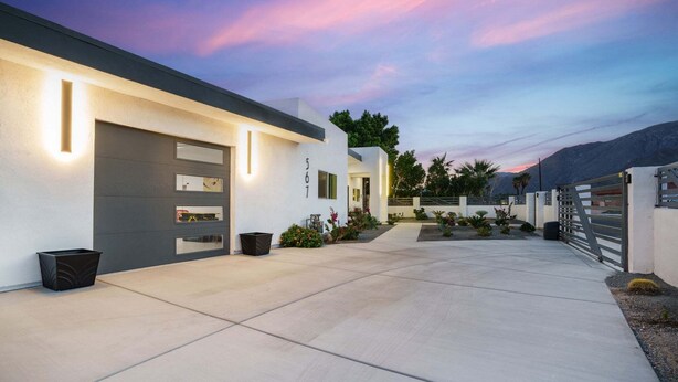 A modern house with a garage, a driveway, and a landscaped garden. - Sunview Escape, a Freshly Remodeled Retreat! (Palm Springs)