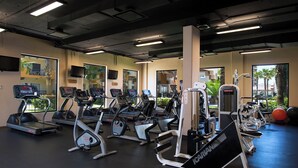 A gym with treadmills, elliptical machines, and weight equipment. - Spend Thanksgiving in a 3-bedroom hotel suites with AC in Cabo San Lucas (Cabo San Lucas)