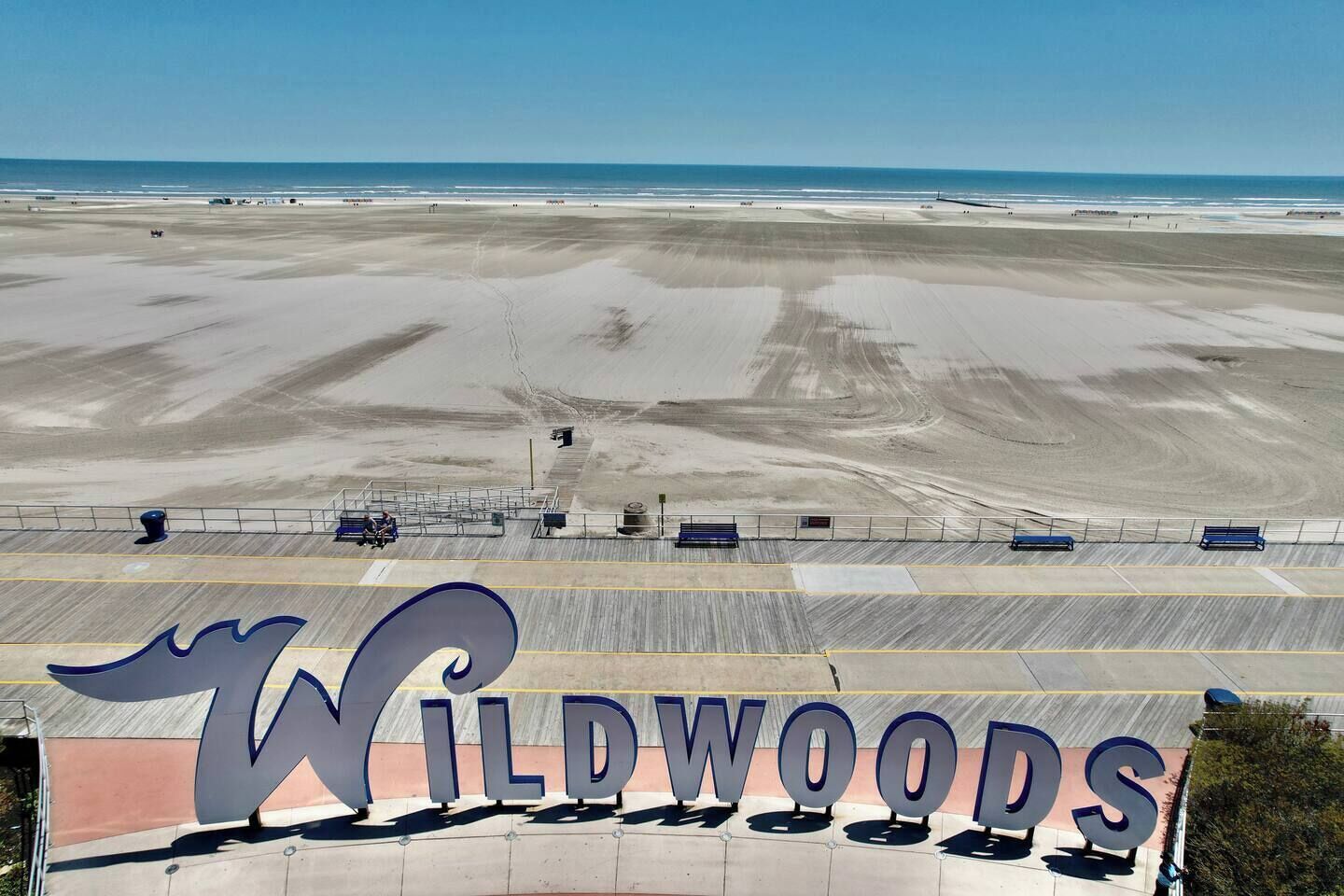 A beach view with a large sign for Wildwoods.