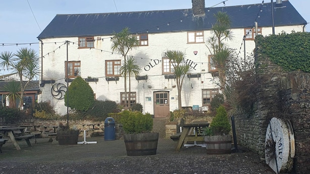 A white building with a dark roof, multiple windows, and a sign reading 'OLD MILL.' - Golden Coast Holiday, Close to Woolacombe Beach (Woolacombe)