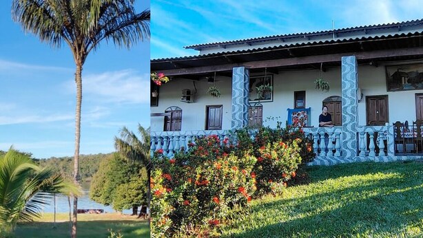 A two-story building with a balcony, a palm tree, and a garden with red flowers. - Guesthouse facing Silves, 5 minutes from the bus terminal, with river access. (Silves)