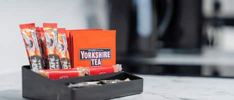 A tray with Yorkshire Tea packets and a box, placed on a marble surface with a blurred background.