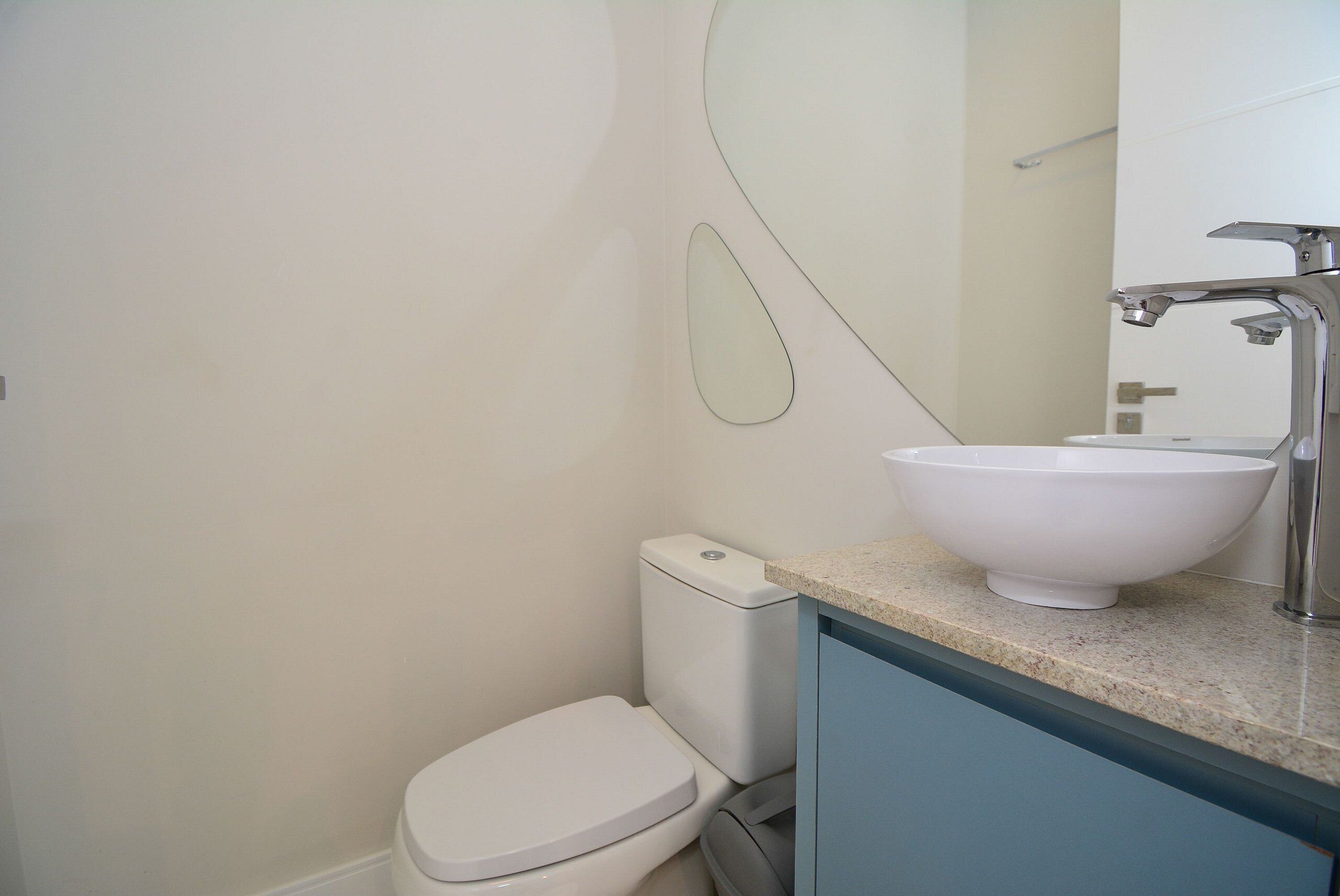 Ein Badezimmer mit Toilette, Waschbecken und Spiegel.