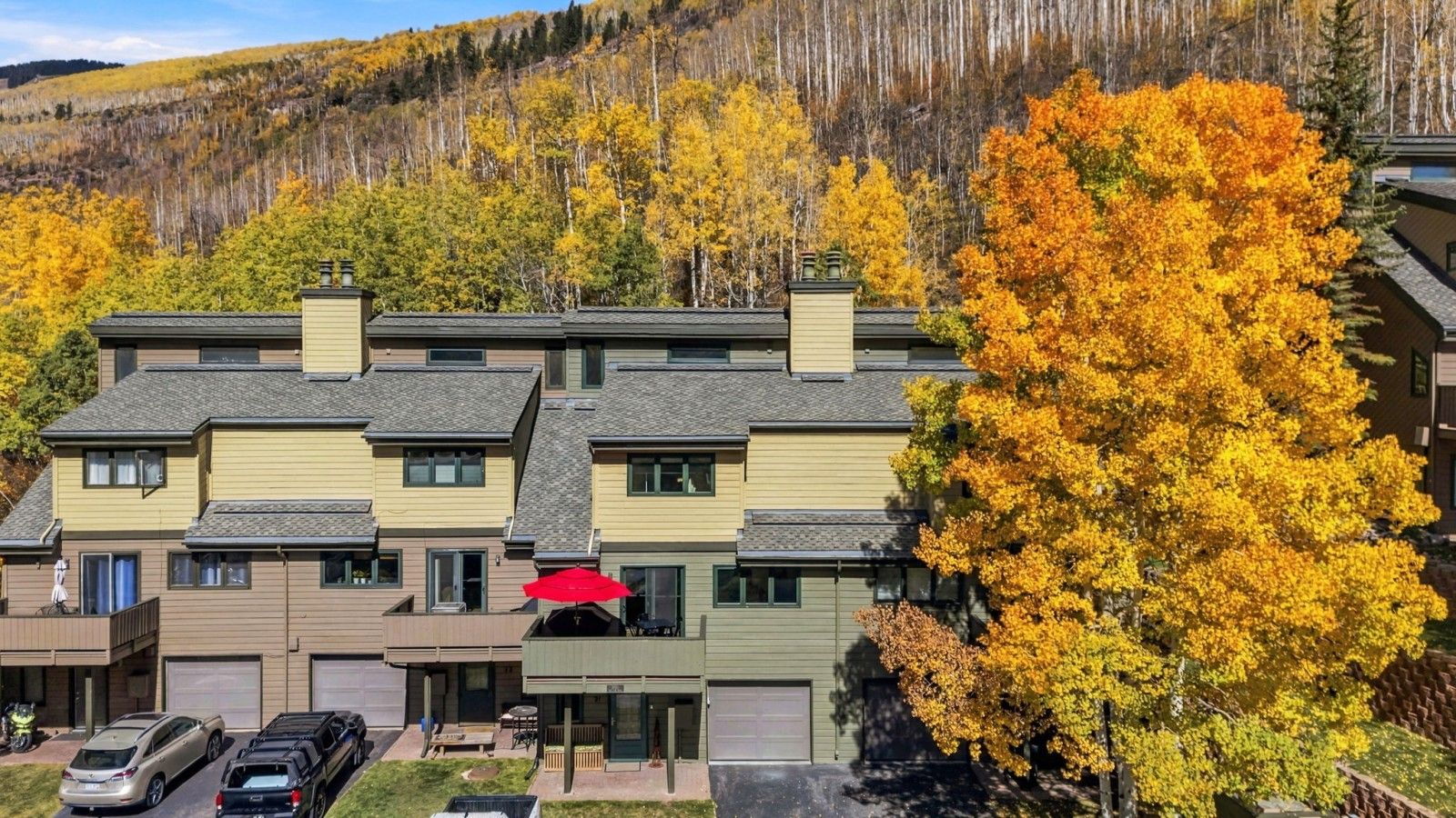 Exterior of the townhome nestled against the mountains with beautiful alpine surroundings