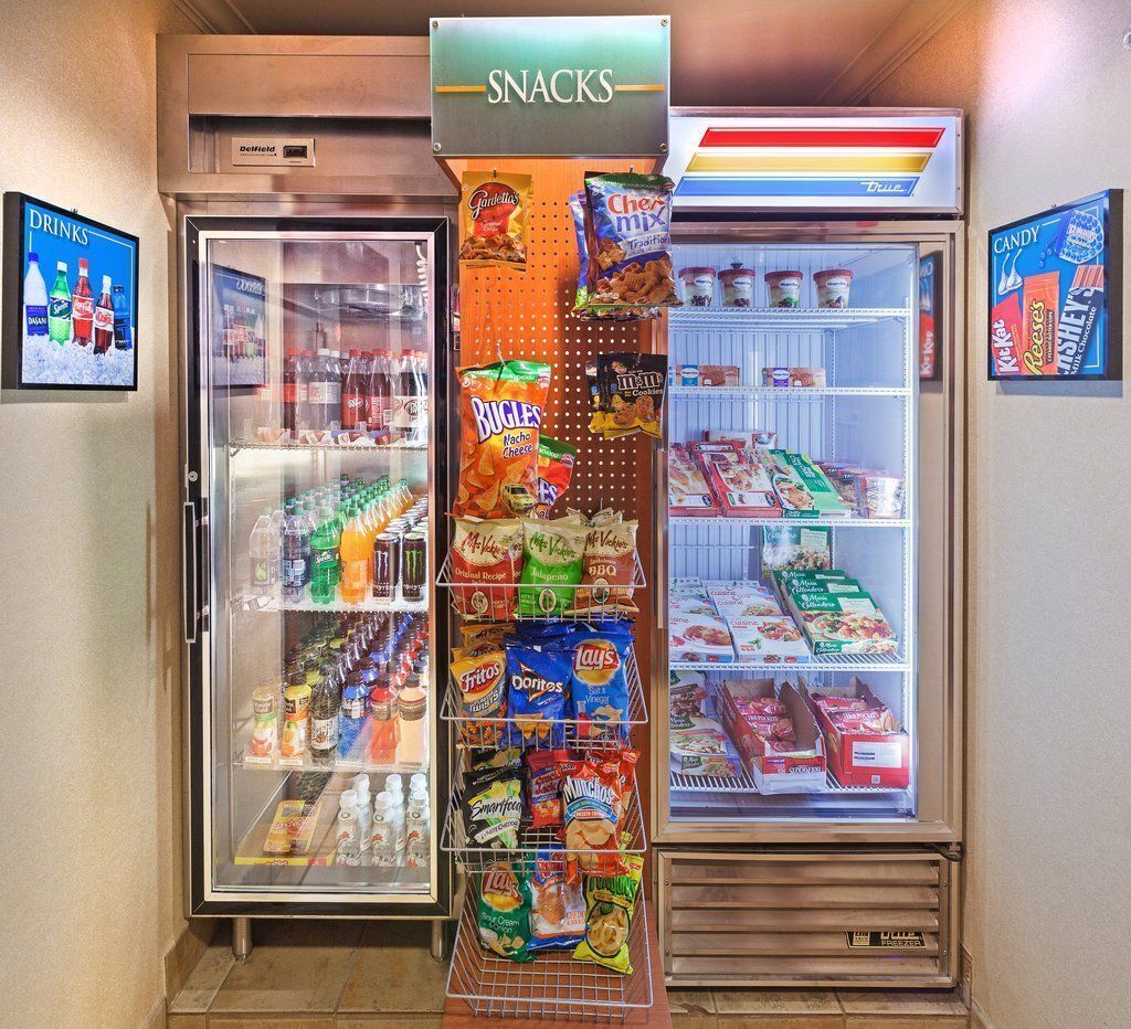 A snack display with various chips and candies.